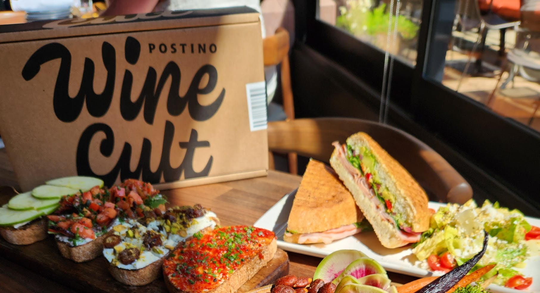 Winecult box next to a sandwich